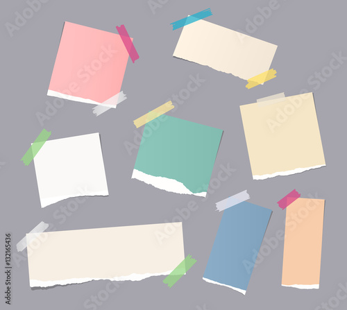 Pieces of different size colorful note, notebook, copybook paper sheets stuck with sticky tape on gray background