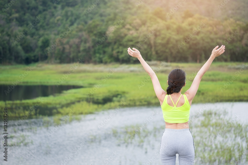 Relaxed woman breathing fresh air raising arms. Relaxed woman breathing fresh air raising arms.