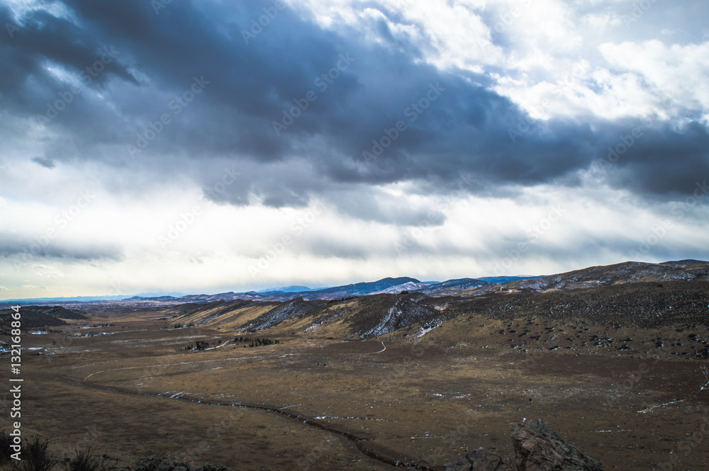 Dark clouds over Colorado mountain valley.