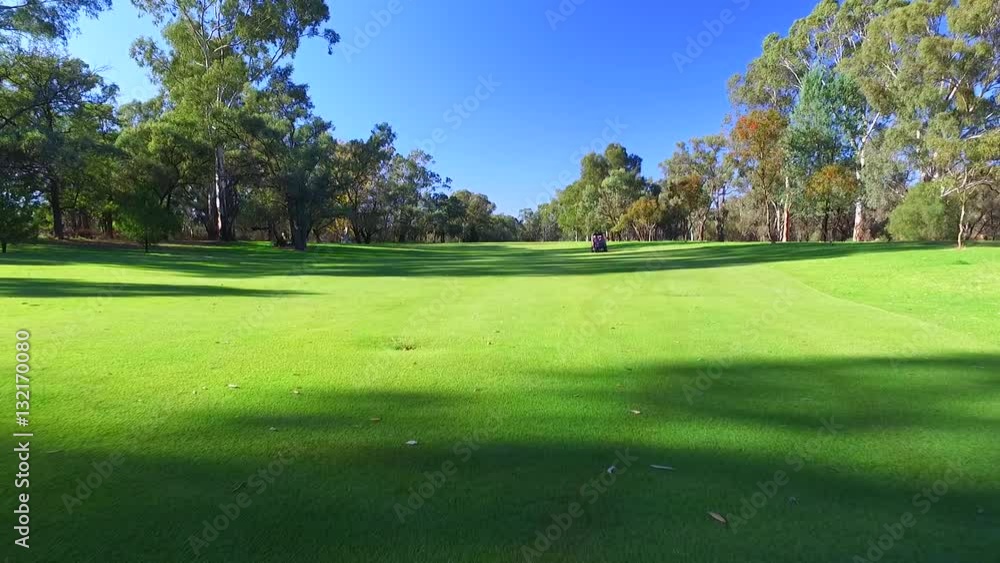 Drone aerial view of Golfers in Electric Golf Buggy with Caddy driving through Golf Course.
Drone aerial view of Golfers in Electric Golf Buggy with Caddy driving through Golf Course.