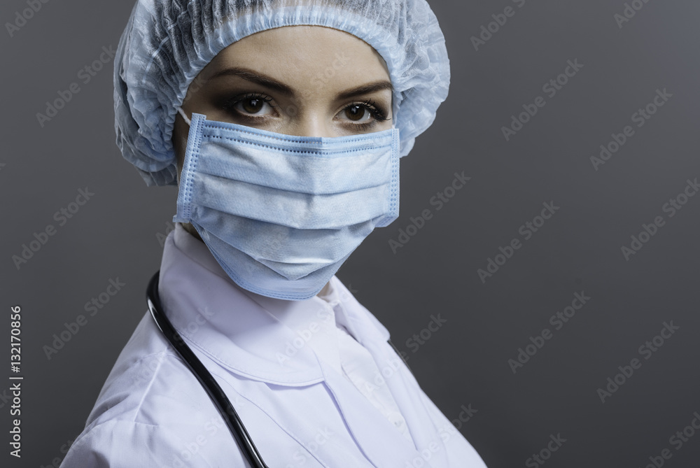 Female doctor gesturing on grey background