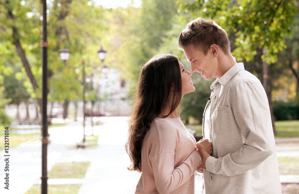 Beautiful young couple outdoors on blurred background Beautiful young couple outdoors on blurred background