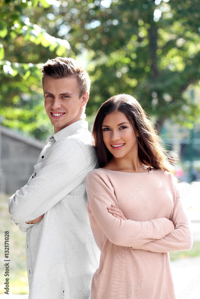 Beautiful young couple outdoors on blurred background Beautiful young couple outdoors on blurred background
