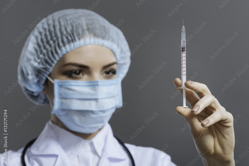 Pretty doctor preparing to make the injection