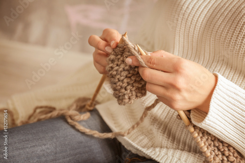 Closeup of woman knitting warm scarf