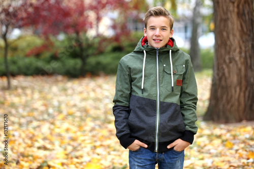 Teenager in park on autumn day