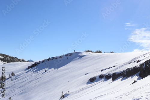 Skiier Looking Over Cliffs © John