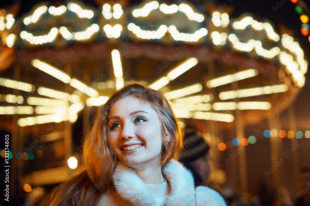 red-haired girl on carousel in winter