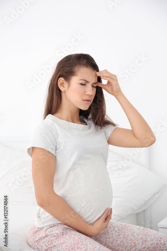 Young pregnant woman feelin...