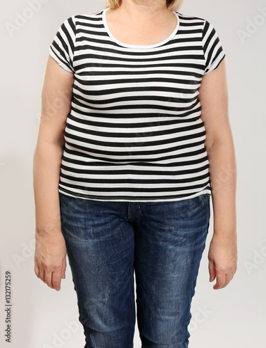 Stout adult woman on light background