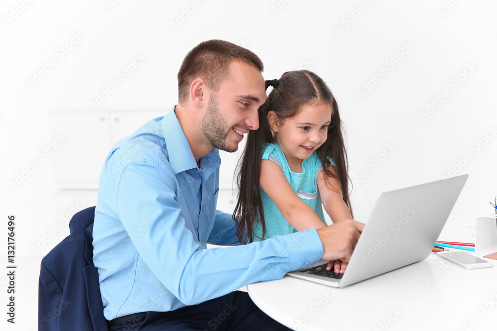 Daughter helping father working in office Daughter helping father working in office
