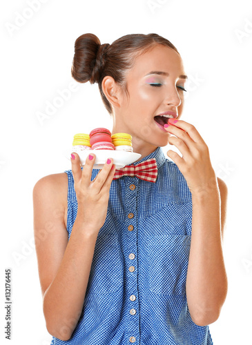 Cute girl with macaroons on...