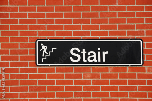 stair sign on brick wall