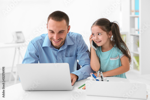 Daughter helping father wor...