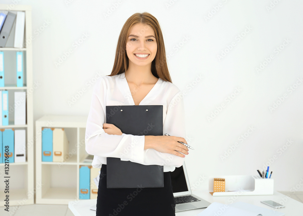 Young attractive woman holding clipboard in office Young attractive woman holding clipboard in office