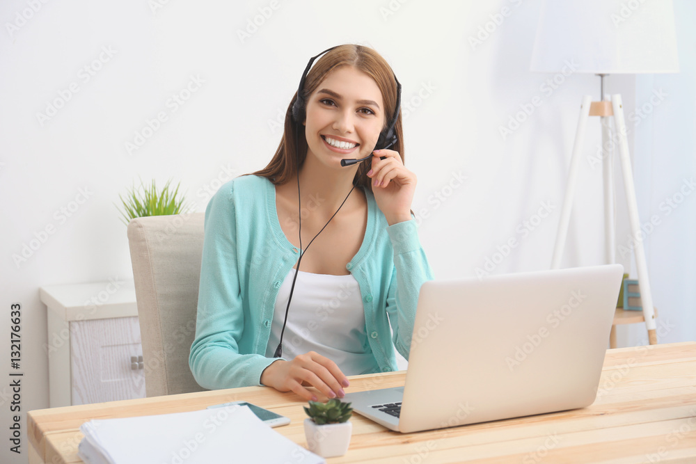 Young beautiful woman with headset sitting at office table Young beautiful woman with headset sitting at office table
