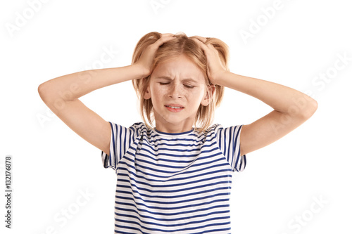 Upset girl with headache is...