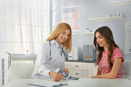 Doctor showing baby ultraso...