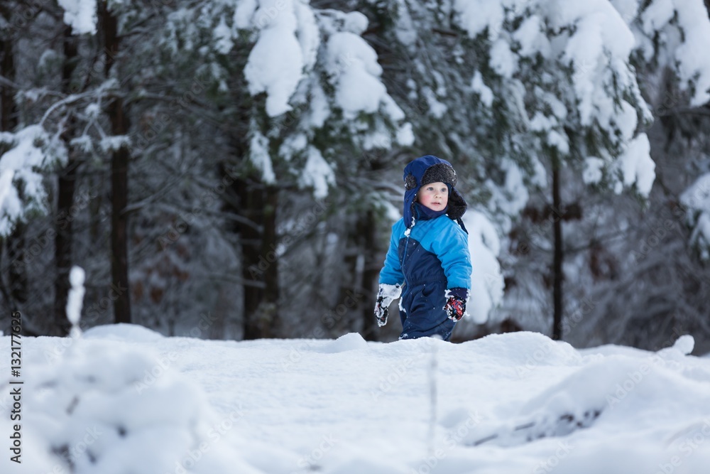 Happy caucasian child playing in snow Happy caucasian child playing in snow