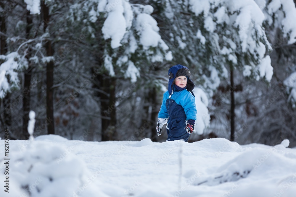 Happy caucasian child playing in snow