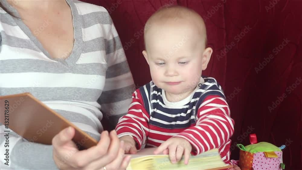 young mother reading a book with baby young mother reading a book with baby
