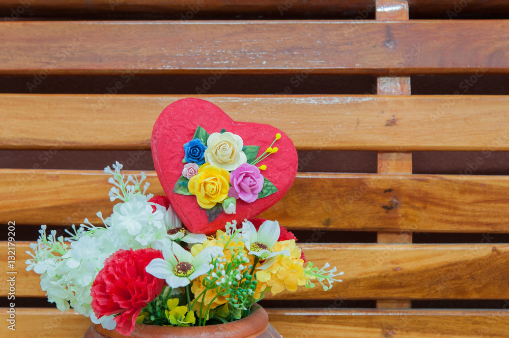 Heart-shaped box with colorful flowers in the season of love.