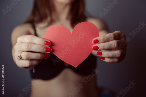 Woman holding big red heart