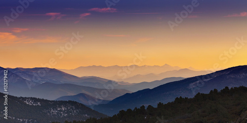 Mountain ranges at sunset receding in layers into the distance. View is from Rowe Peak near Dayton, Nevada