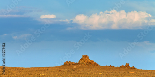 Nevada landscape at sunset near Lovelock, NV. Tufa rock formations under blue sky.