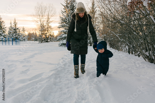 Mother with toddler walking in the snow