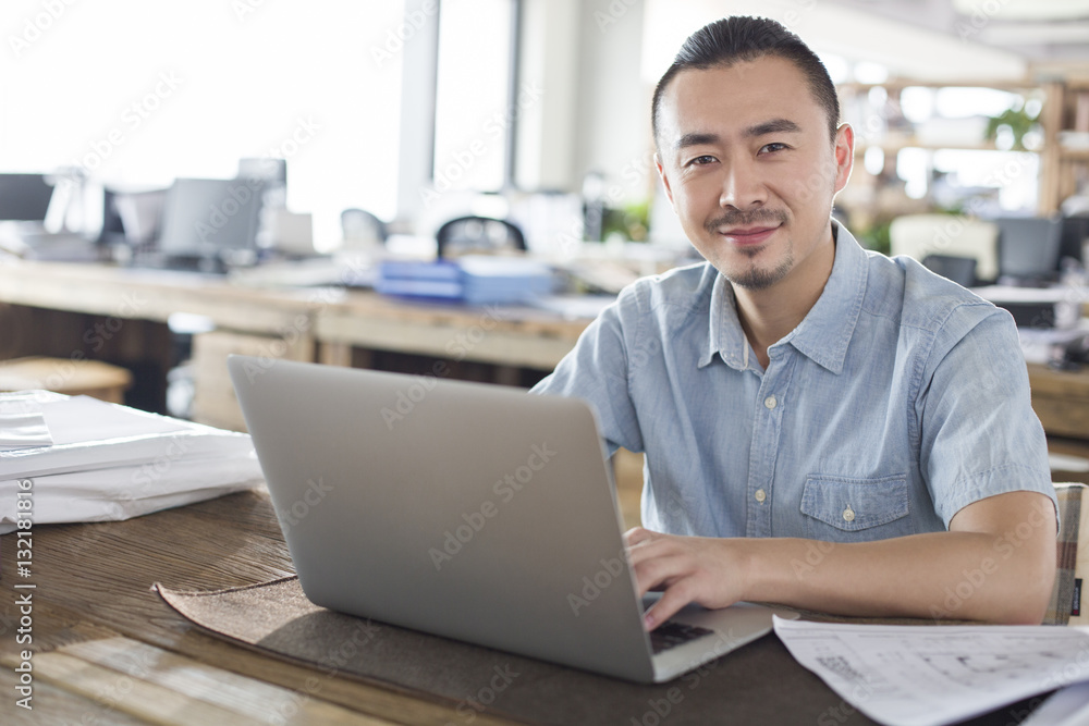 Male architect using laptop in the office Male architect using laptop in the office