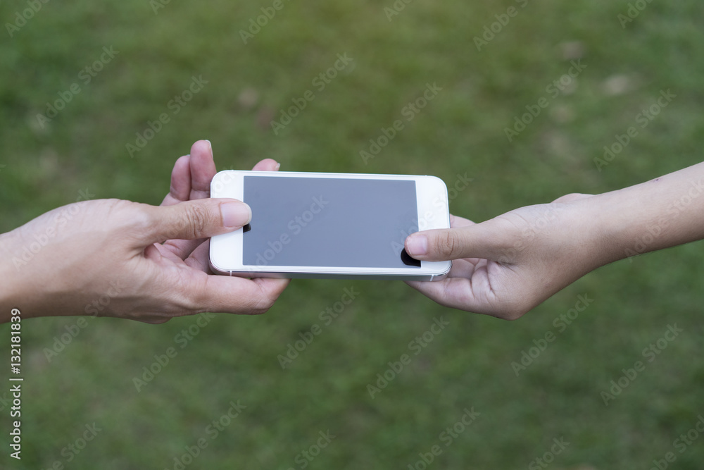 A mother giving her child a mobile phone
