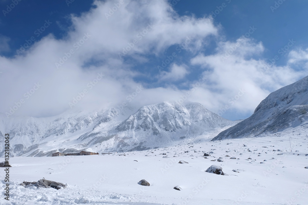 Mudoro field in November with snow mountain background Mudoro field in November with snow mountain background