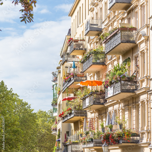 Photography Traditional European residential house with balconys with colorful flowers and flowerpots