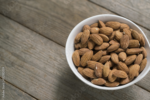 Almond nuts on wood background