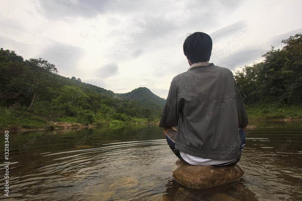 single young man meditate on stone in river on his disappointed holiday (Khiriwong Fuit Village ,Nakhon Si Thammarat Province) single young man meditate on stone in river on his disappointed holiday (Khiriwong Fuit Village ,Nakhon Si Thammarat Province)