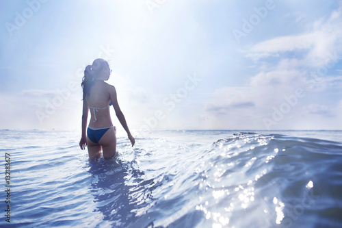 Woman standing in waves at beach
