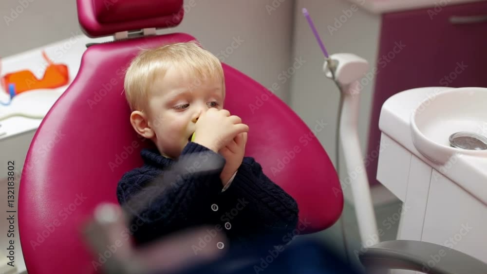 Cute little boy with green apple in the dental clinic. Cute little boy with green apple in the dental clinic.