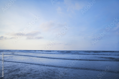 View of beach and waves at sunrise