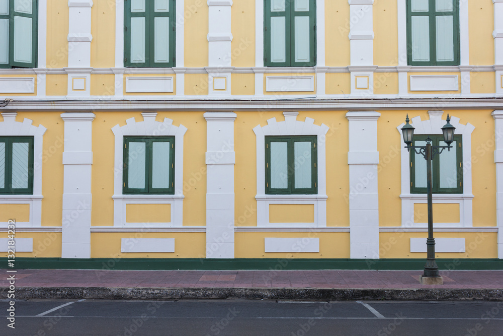 pattern of the road beside the yellow building