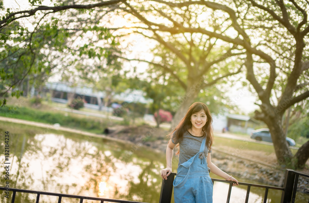 Portrait of cute young woman smiling relaxing in park enjoying her freedom wear short dress Portrait of cute young woman smiling relaxing in park enjoying her freedom wear short dress