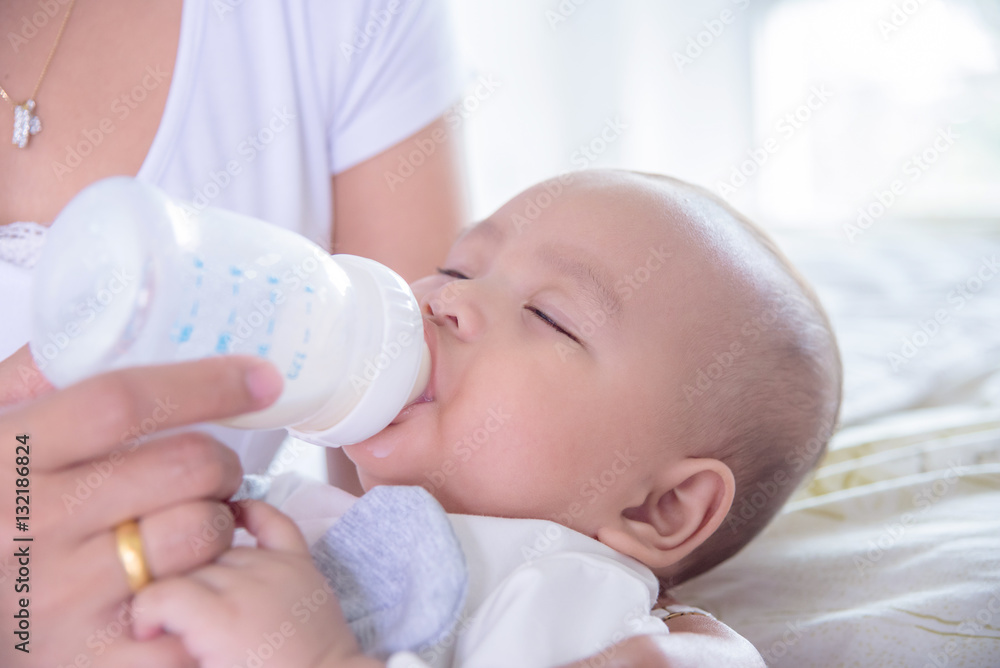 Little asian child drinking milk from bottle Little asian child drinking milk from bottle