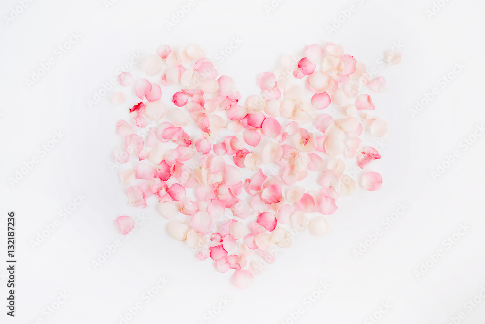 Heart symbol made of pink rose petals. Valentine's day background. Flat lay, top view Heart symbol made of pink rose petals. Valentine's day background. Flat lay, top view