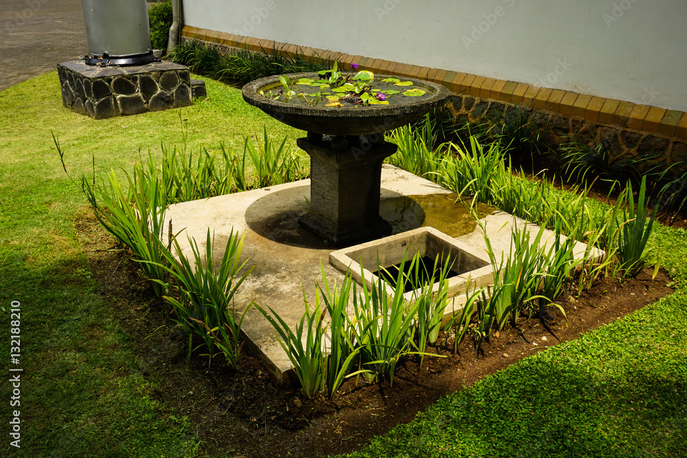 Beautiful garden with green grass and water fountain photo taken in Semarang Indonesia