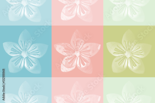 Origami flower on blue, pink and green background