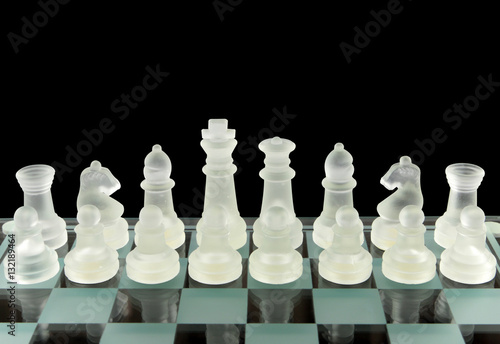 Chess set in glass on a glass board