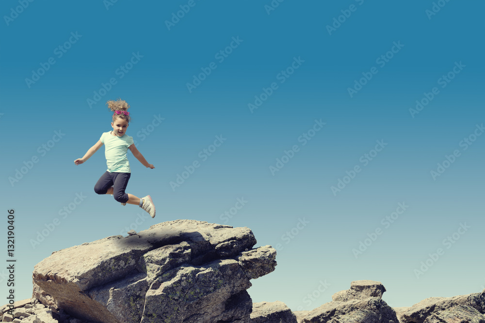 Little girl jumping on stone. Little girl jumping on stone.