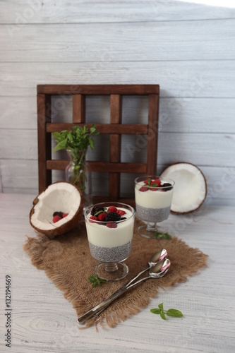 Fresh homemade coconut yogurt in glass cups served with fresh berries