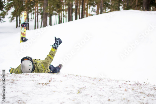 Fotografija Snowboarder lying in the snow