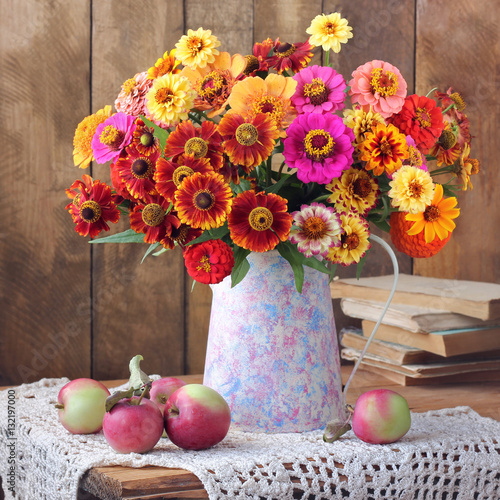 Summer still life with a bouquet and apples.